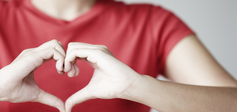 Woman Making Heart Shape with Hands